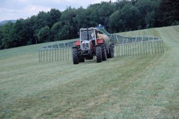 Tractor on the field applying liquid manure