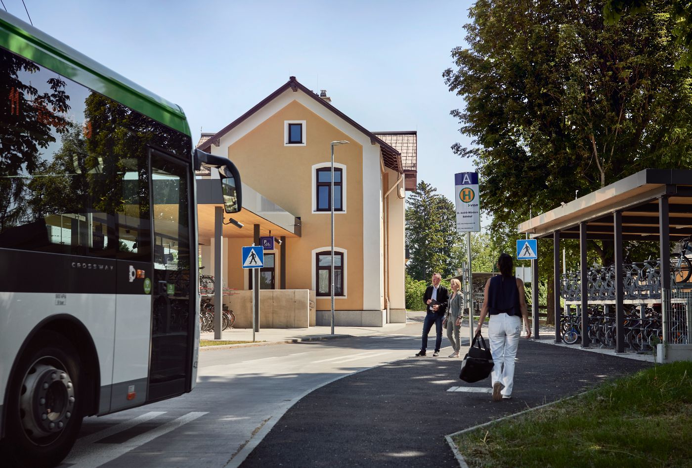 People wait at a bus stop